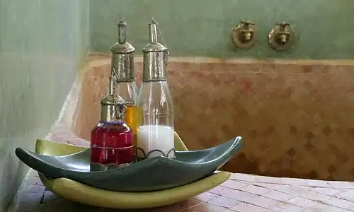 Private hammam room with marble and warm lighting.